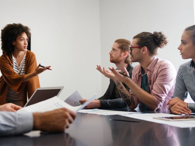 Happy african american female leader holding negotiations meeting with friendly diverse colleague